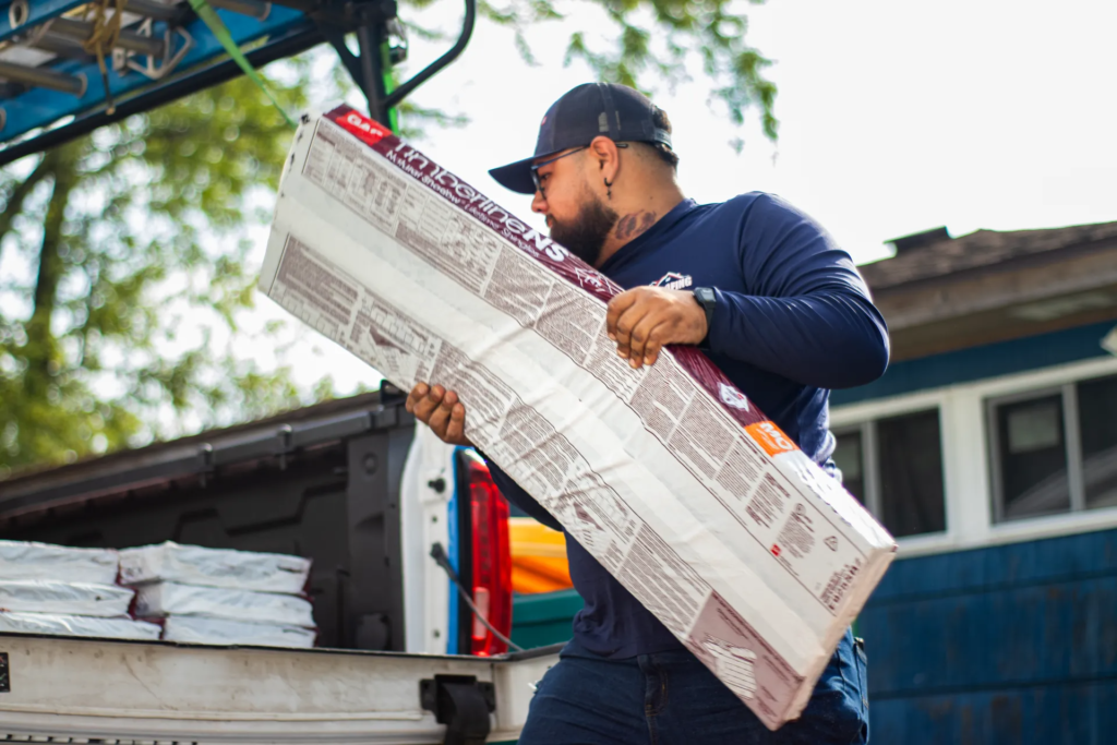 roofer unloading GAF shingles