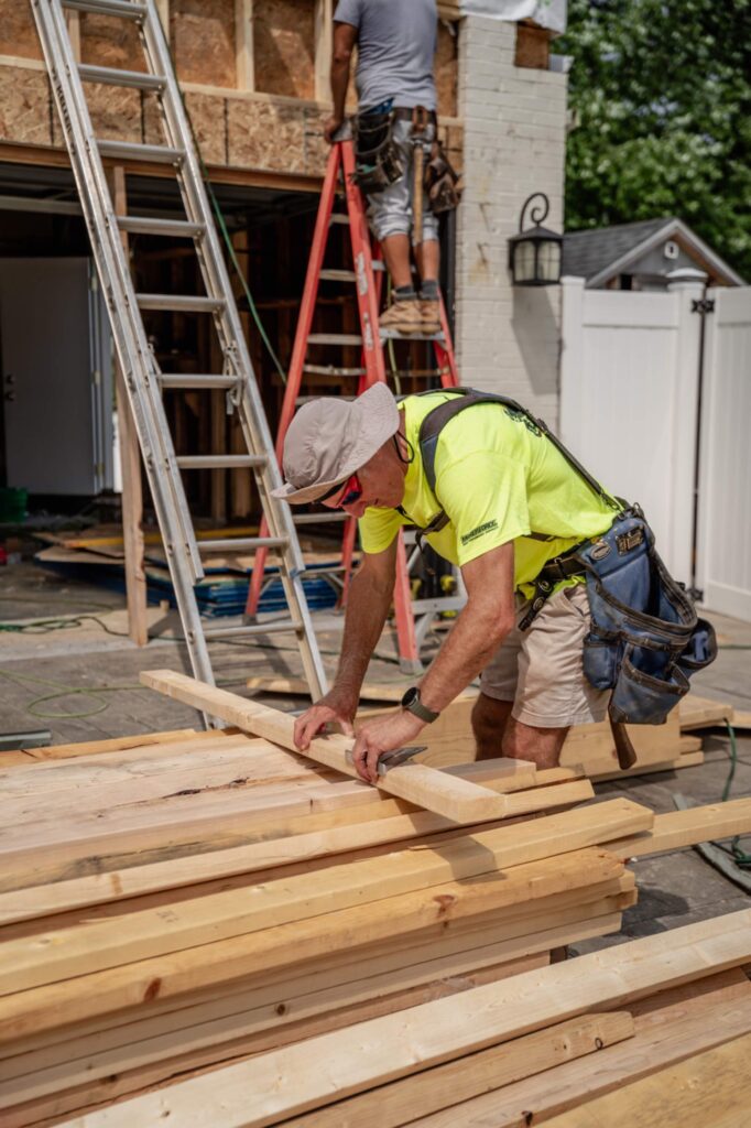 carpenter measuring lumber construction