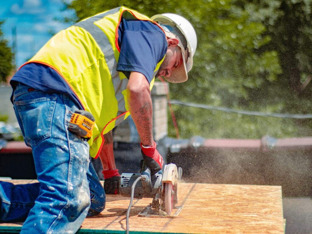 worker cutting roof plywood