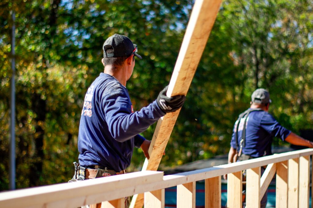 crew lifting lumber framing