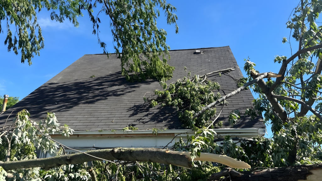 emergency roof repair Indiana contractor inspecting storm damaged roof after severe weather